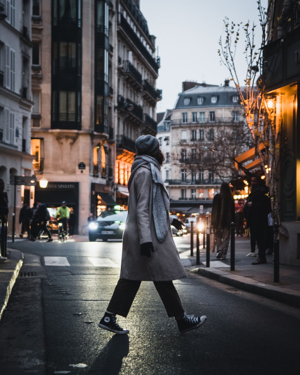 a person in a garment walking down a street