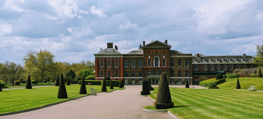 a large building with a lawn in front of it with Kensington Palace in the background