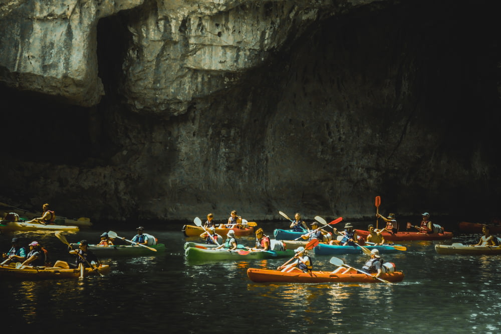 a group of people in canoes in a river