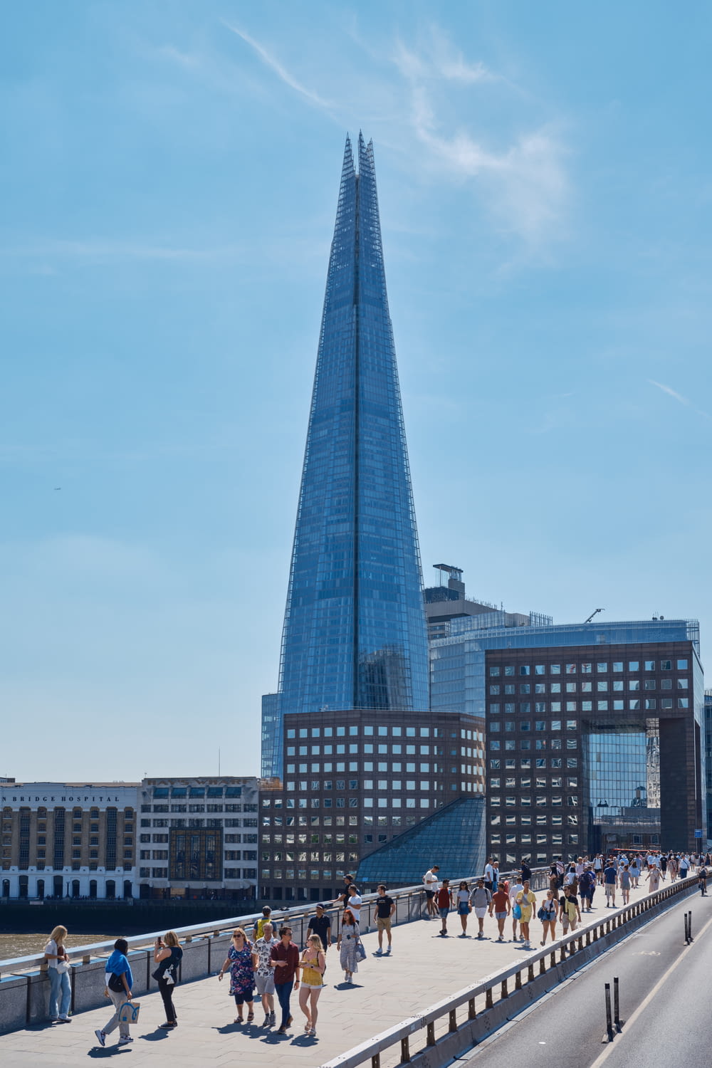 a tall glass building with The Shard in the background