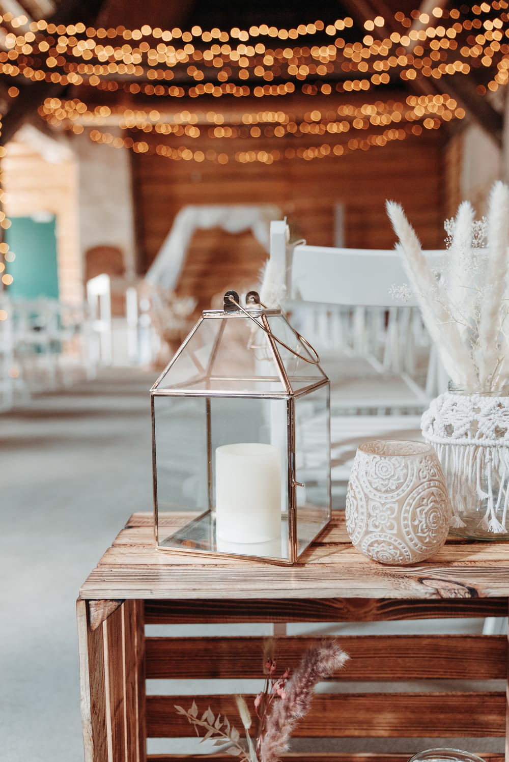 a table with a glass lantern and a candle on it