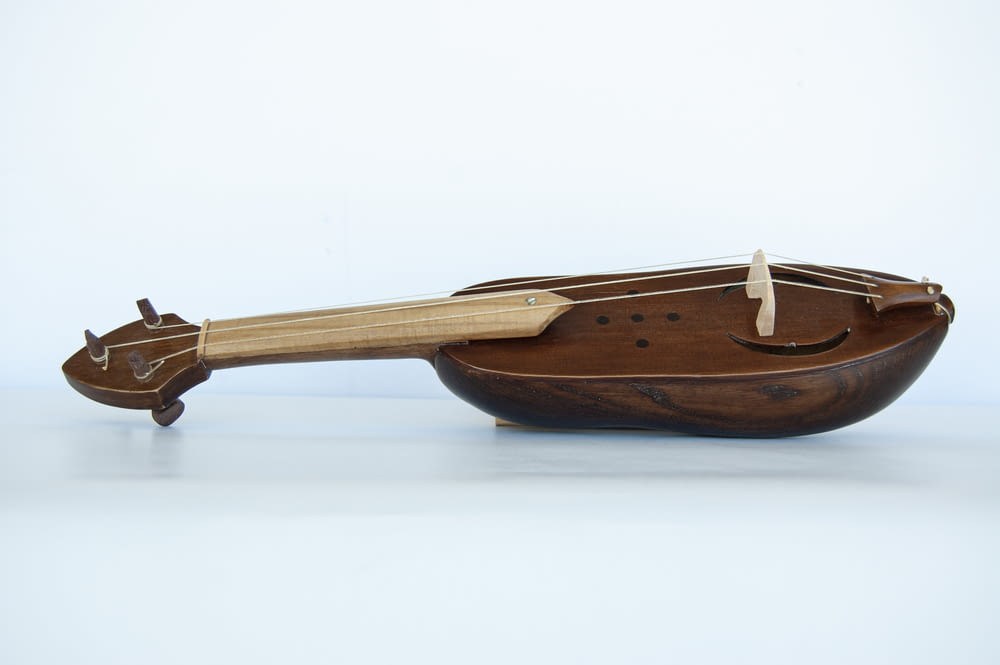 a wooden boat with a paddle