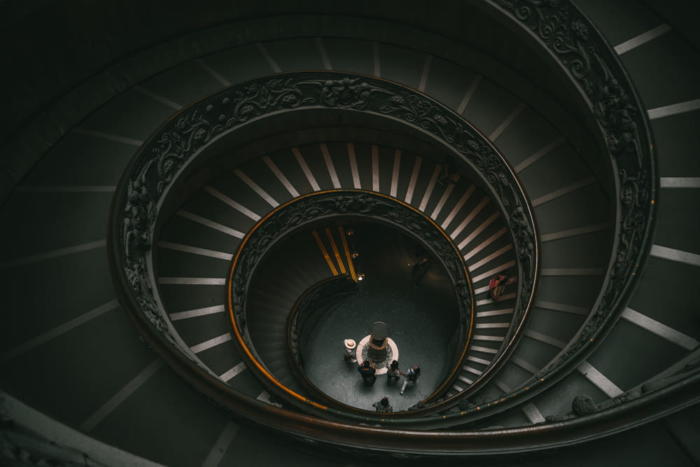 a spiral staircase with people