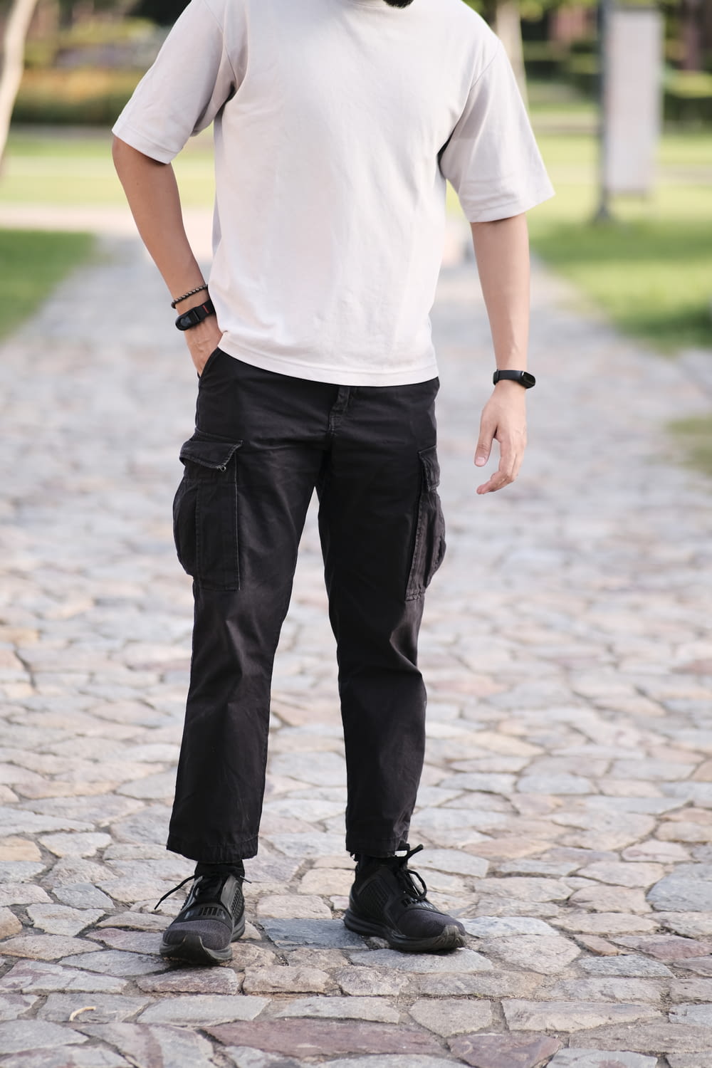 a man wearing a white shirt and black pants