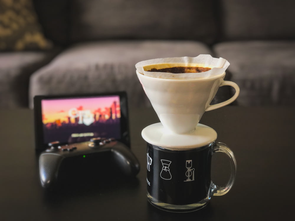 a coffee cup and a remote control