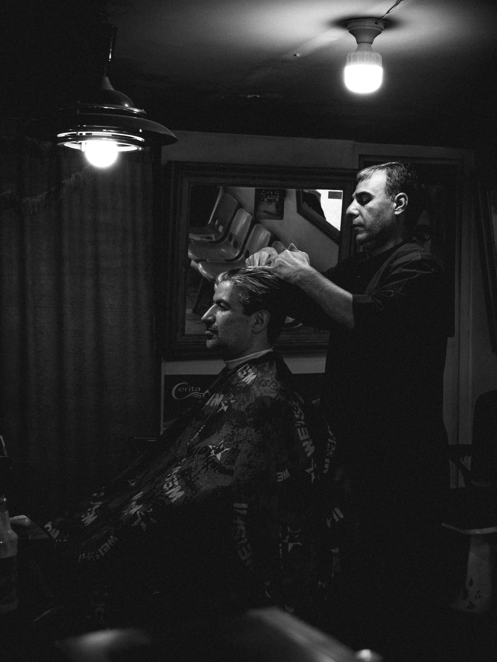 a man cutting another man's hair