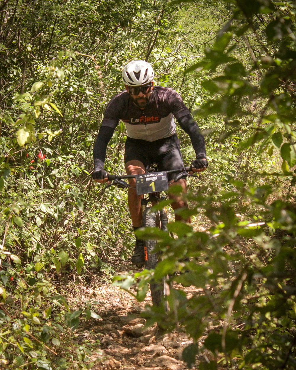 a man riding a bike through the woods