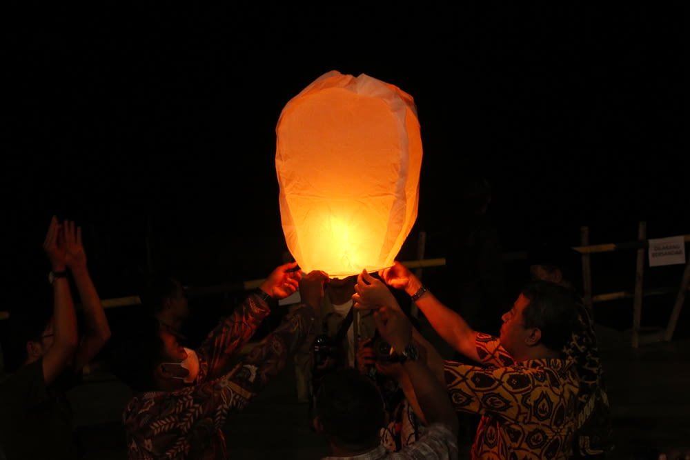 a group of people holding a light
