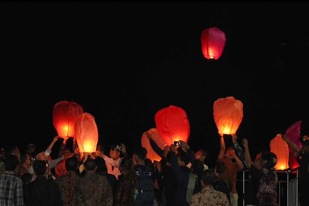 a group of people holding red lanterns
