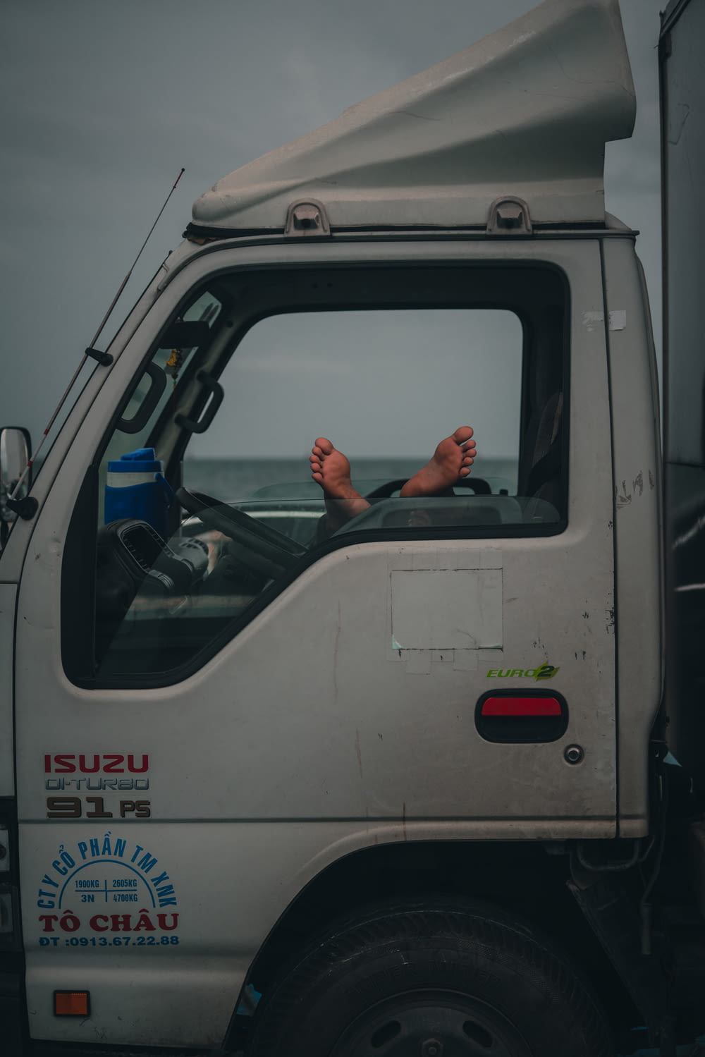 a person waving from a vehicle