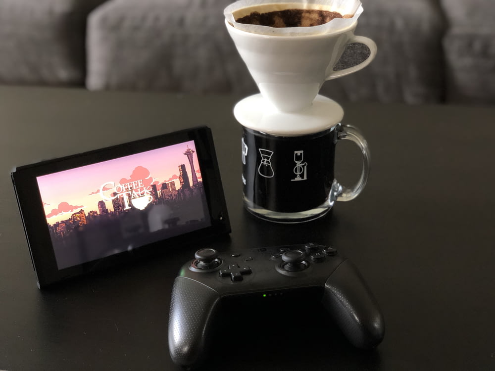a coffee cup and a remote control on a table