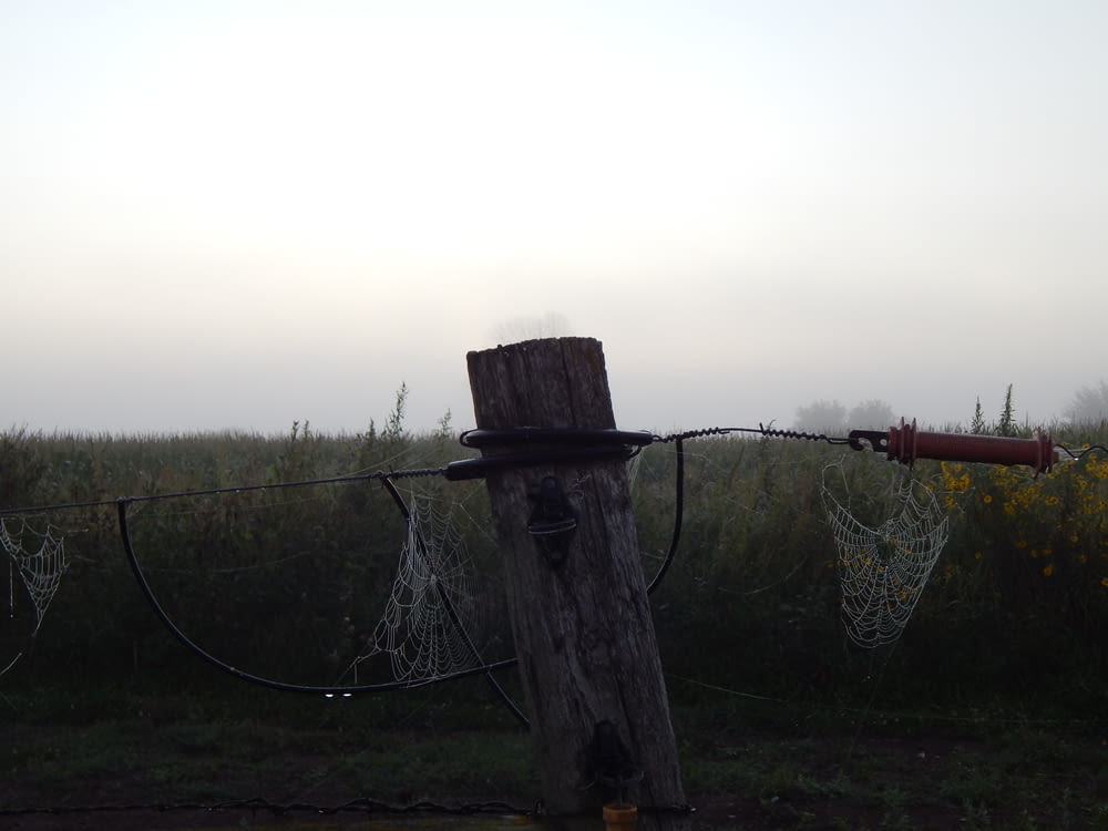 a fence with a net and a field in the background
