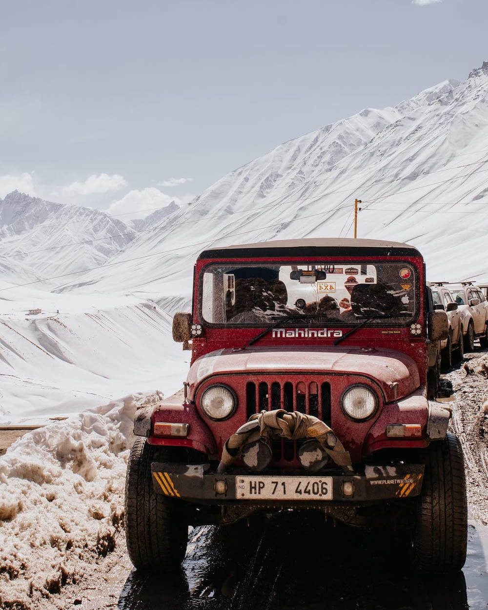 a red jeep on a snowy road