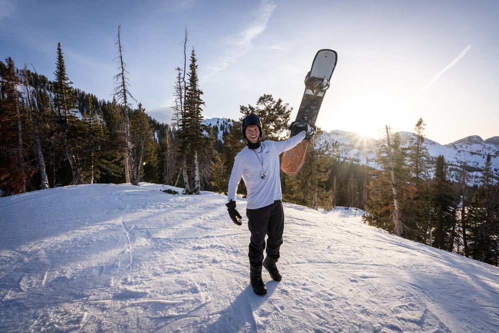 a man holding a snowboard
