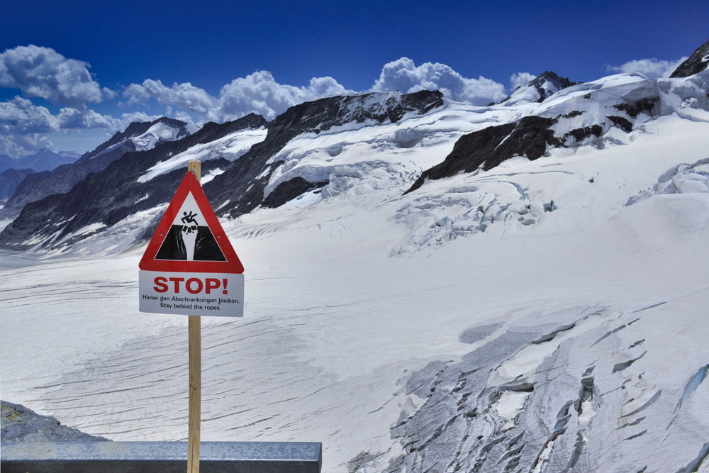 a sign on a snowy mountain