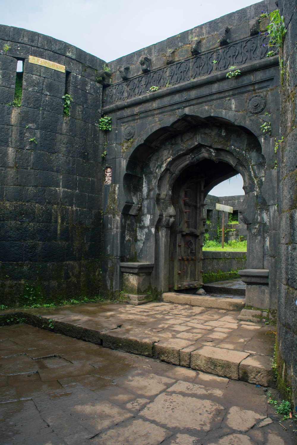 a stone archway with a stone walkway