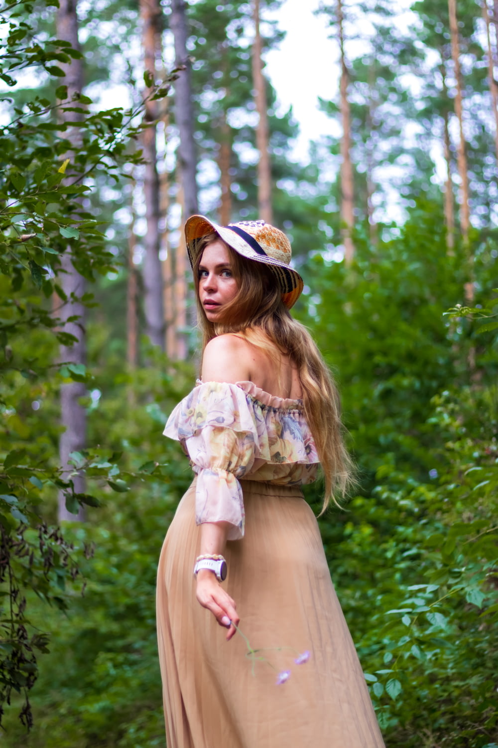 a woman in a dress in the woods