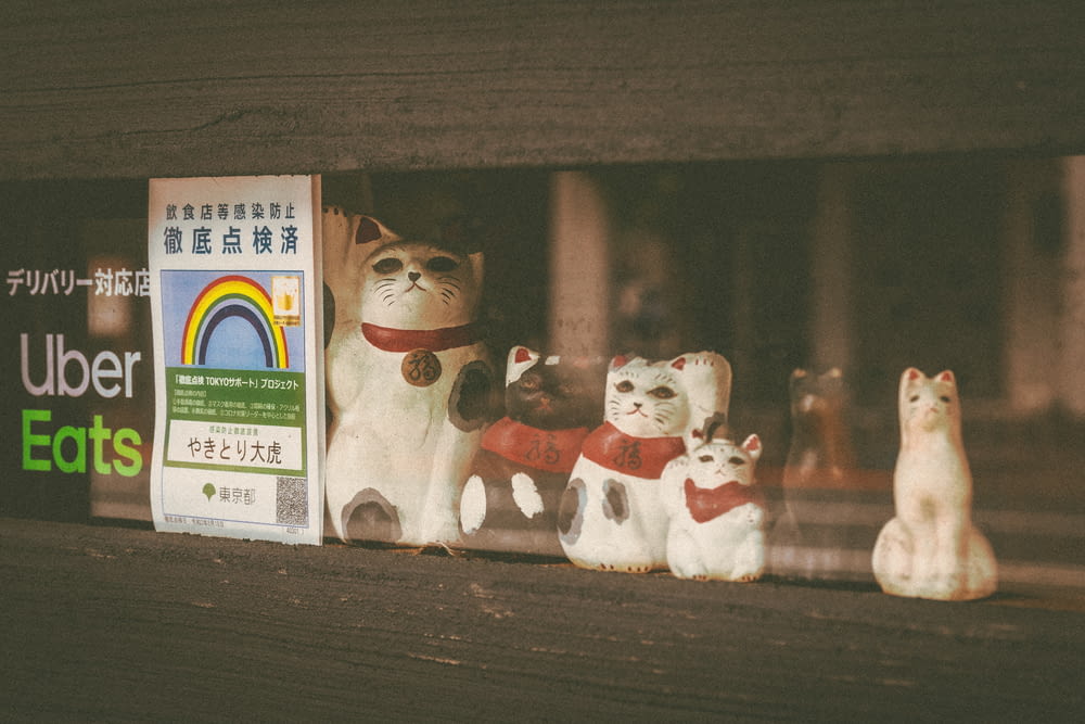 a group of cats on a shelf