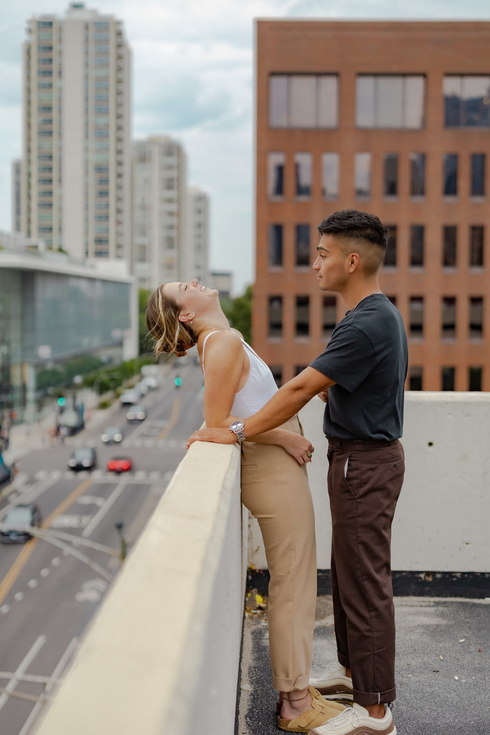 a man and woman kissing on a rooftop