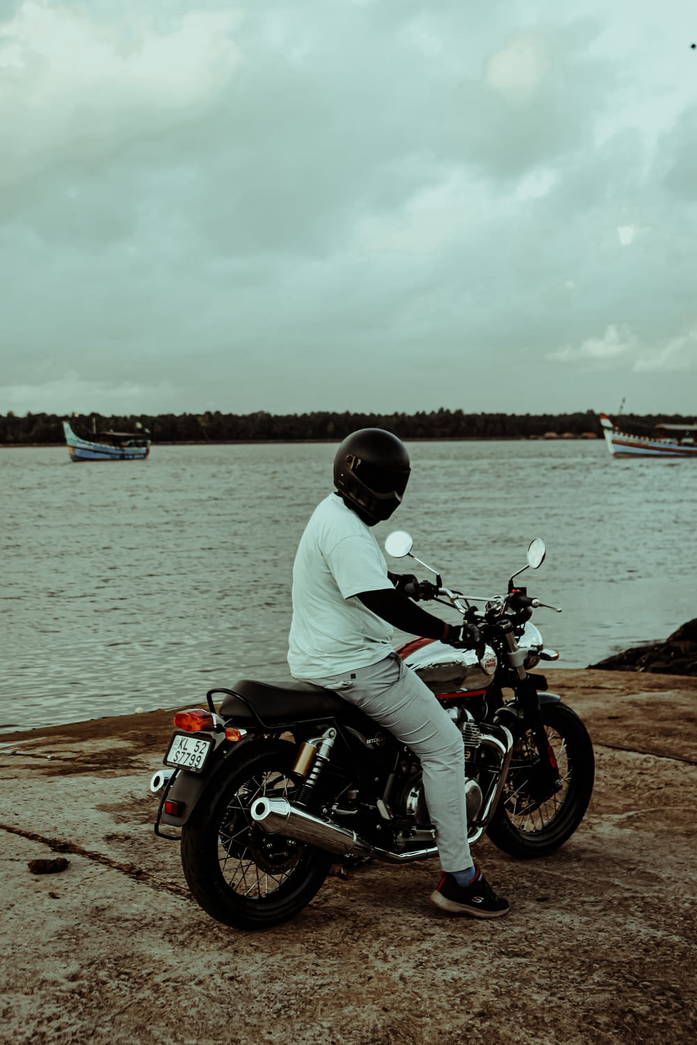 a man on a motorcycle on a beach