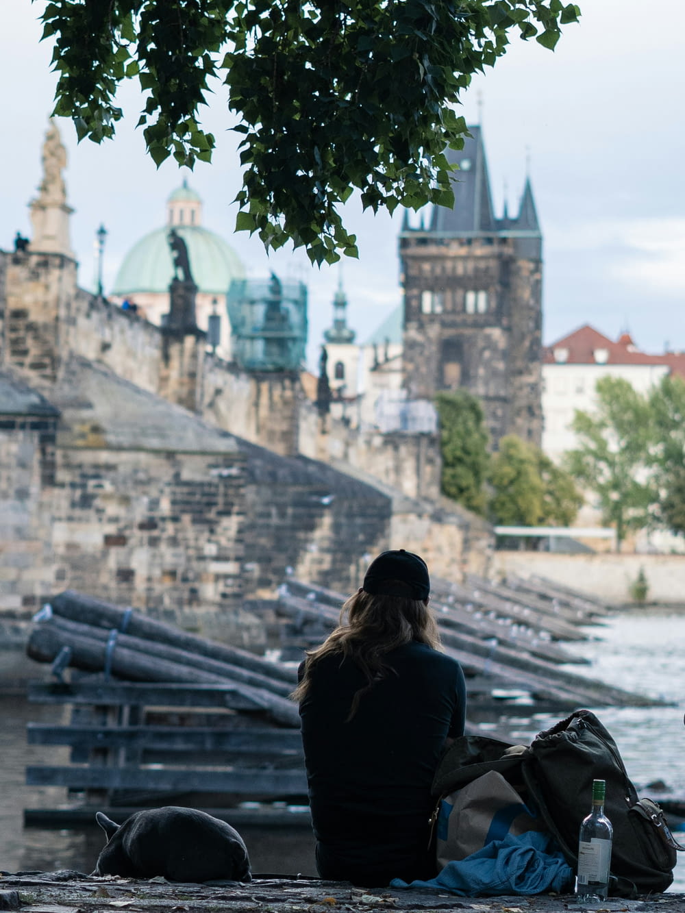 a person sitting on a bench looking at a castle