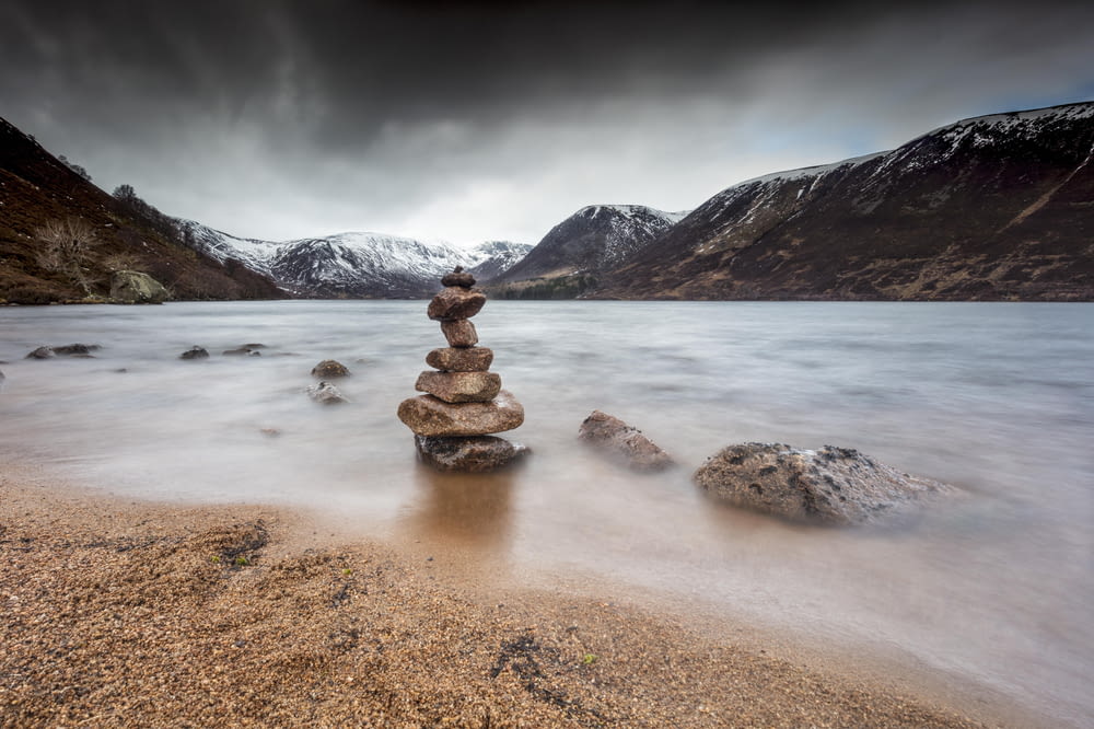 a stack of rocks in a lake
