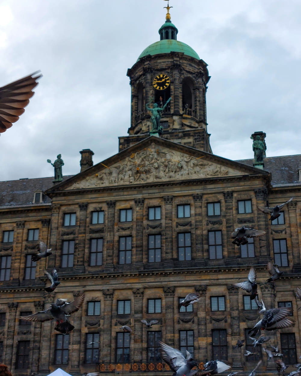 a clock tower on top of Royal Palace of Amsterdam