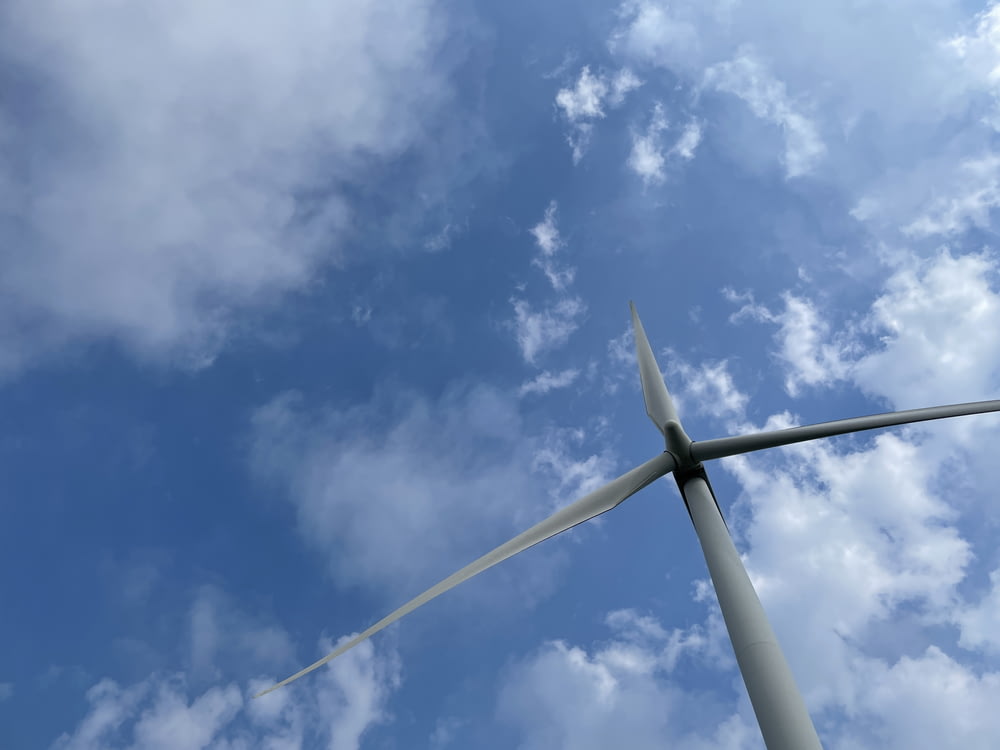 a wind turbine under a blue sky