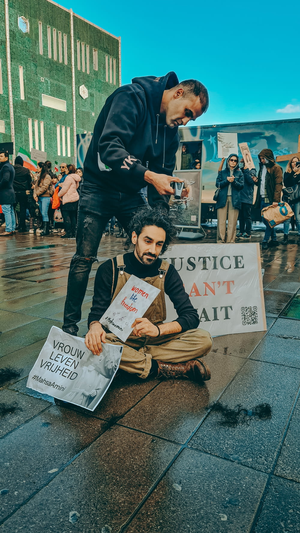 a man holding a sign and another man holding a sign