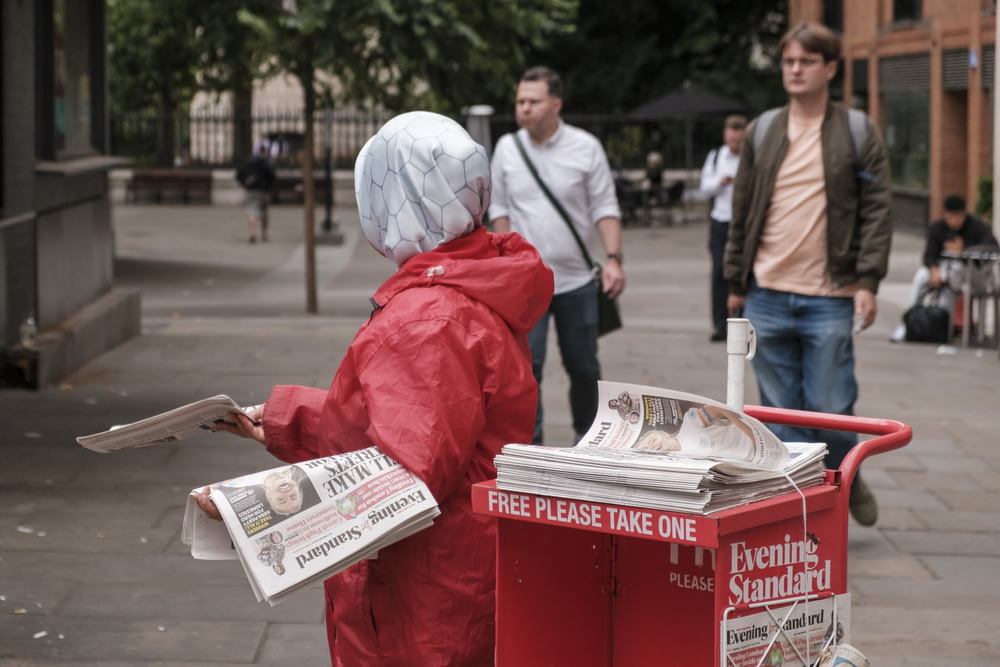 a person in a garment reading a newspaper