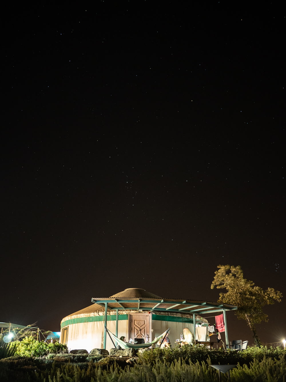 a building with a green roof at night