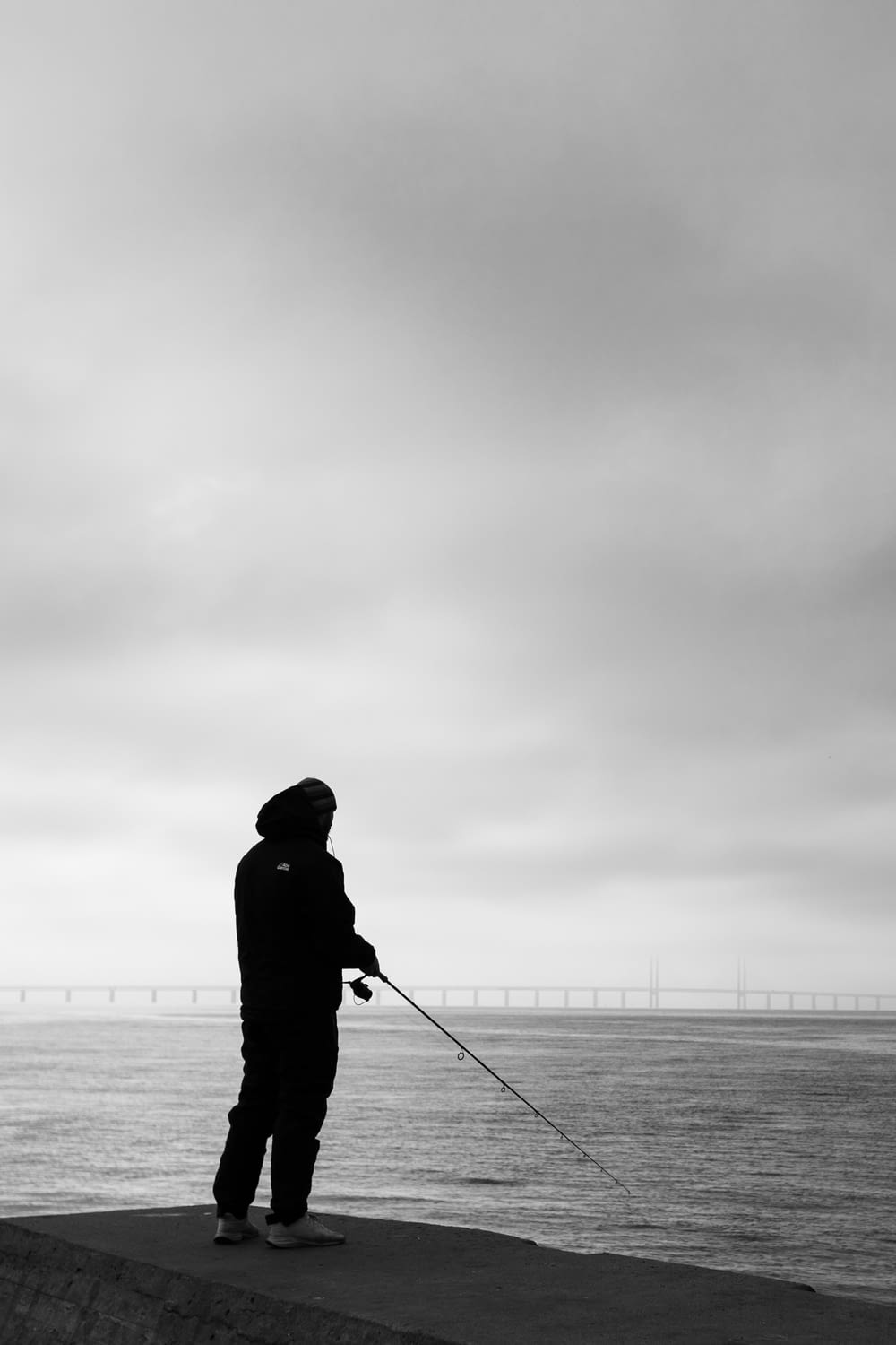 a person fishing on a pier