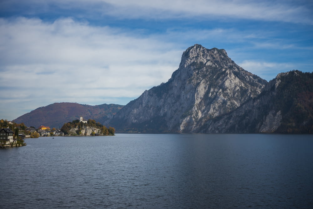 a body of water with a mountain in the background