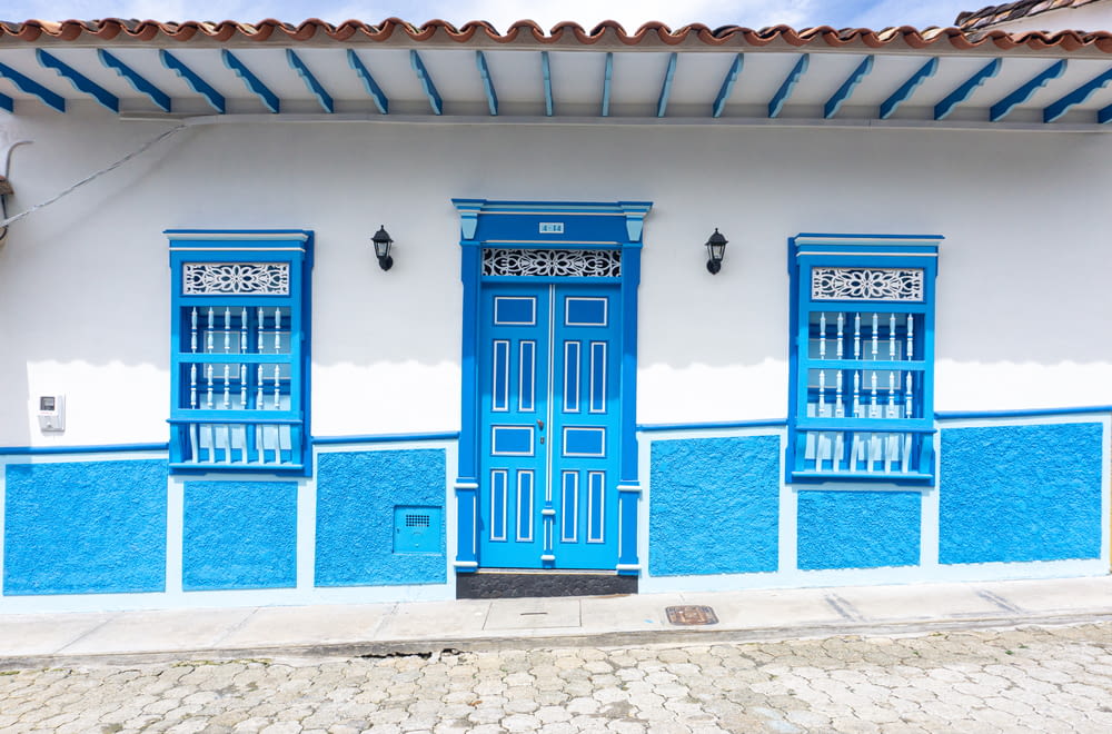 a blue building with a few doors