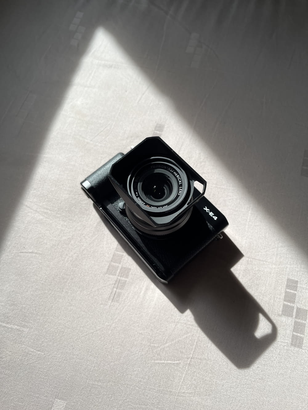 a black camera on a white surface