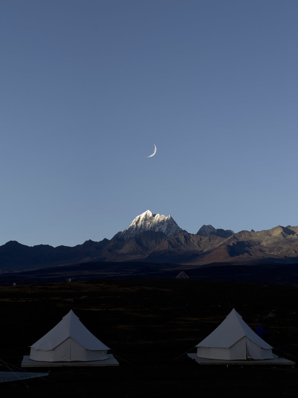 a group of tents in front of a mountain