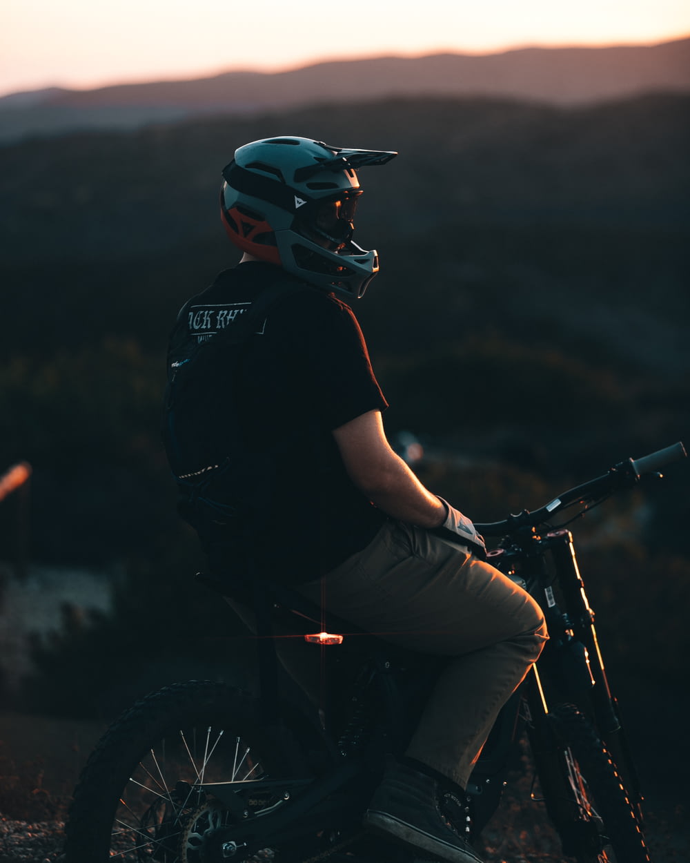 a man wearing a helmet and riding a motorcycle