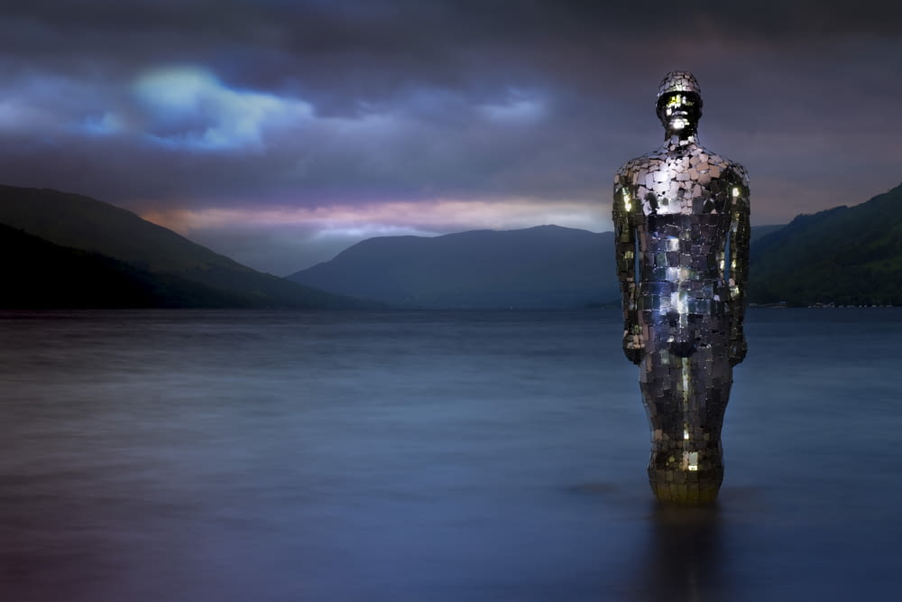 a statue in the middle of a body of water