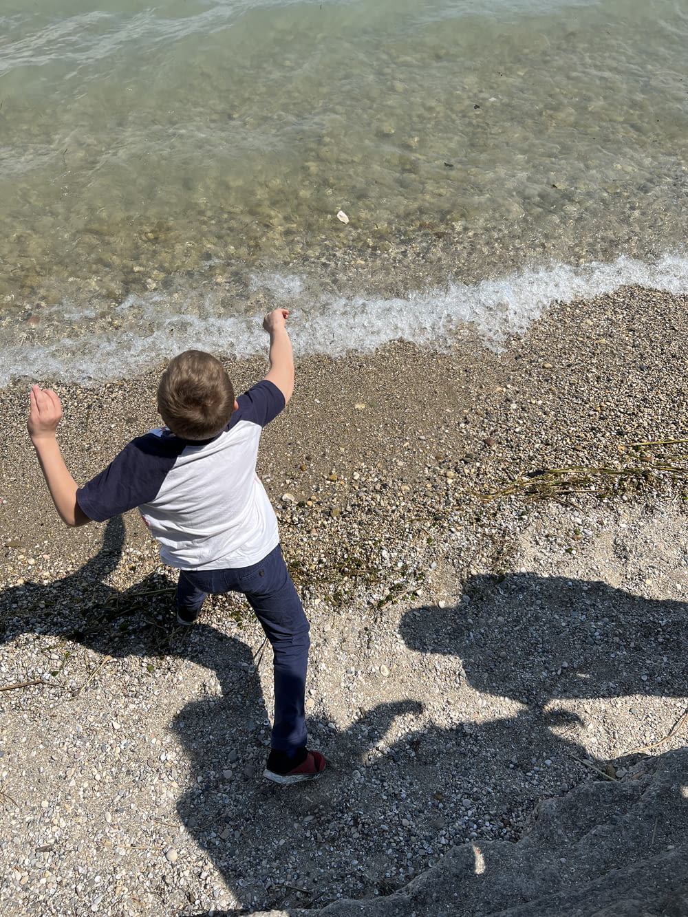 a boy standing on a beach