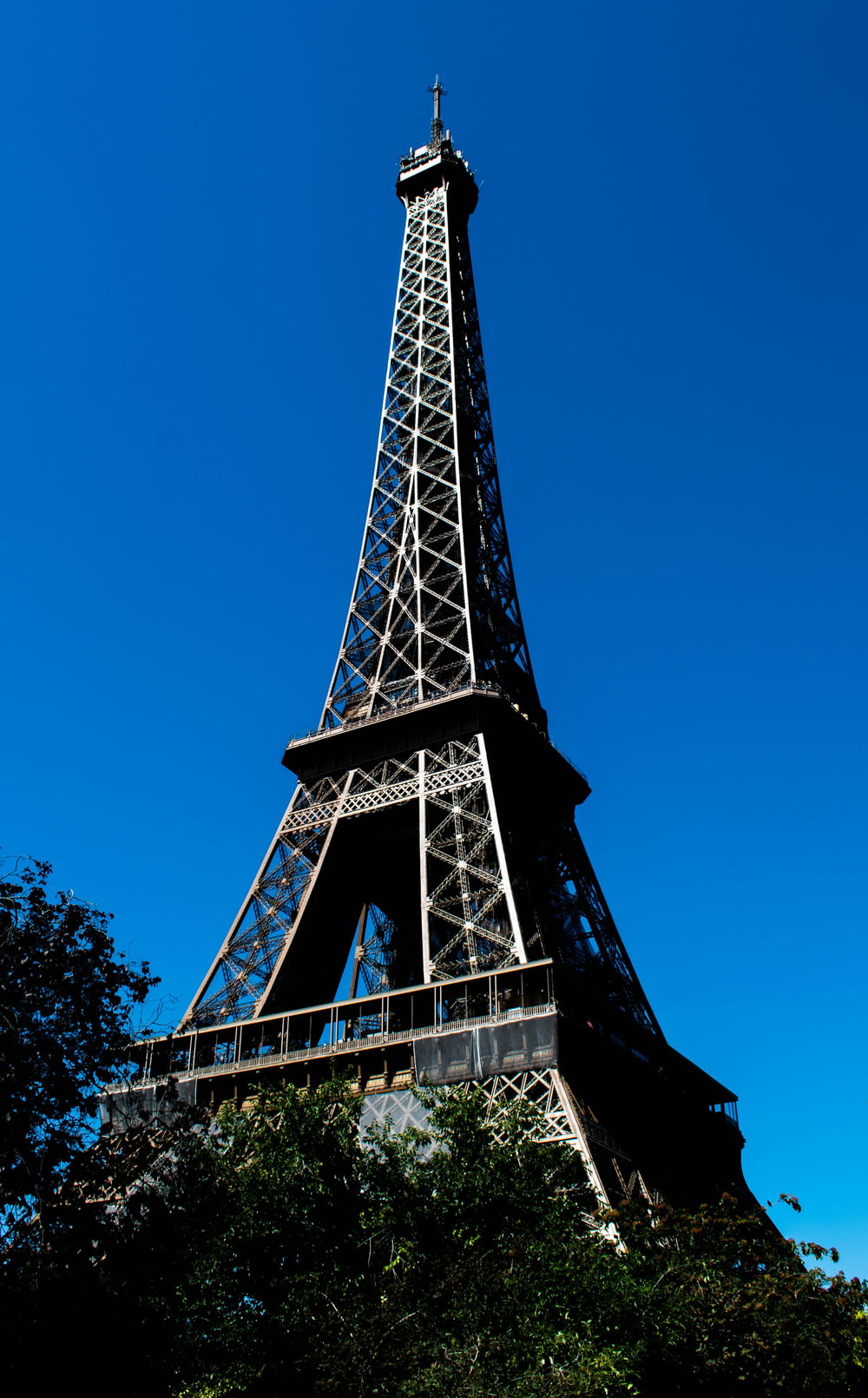 a tall metal tower with Eiffel Tower in the background