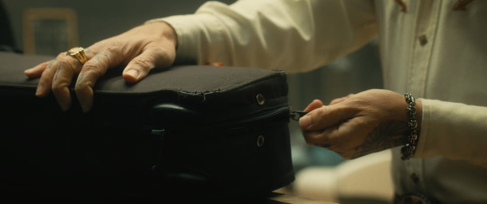 a close-up of hands holding a briefcase