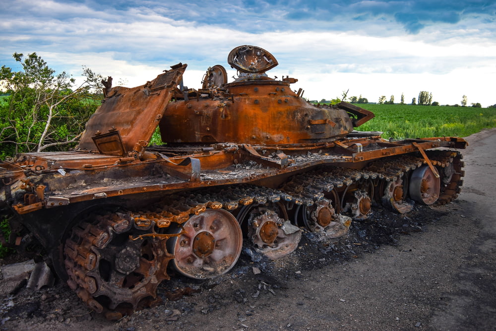 a rusted out tank on a road