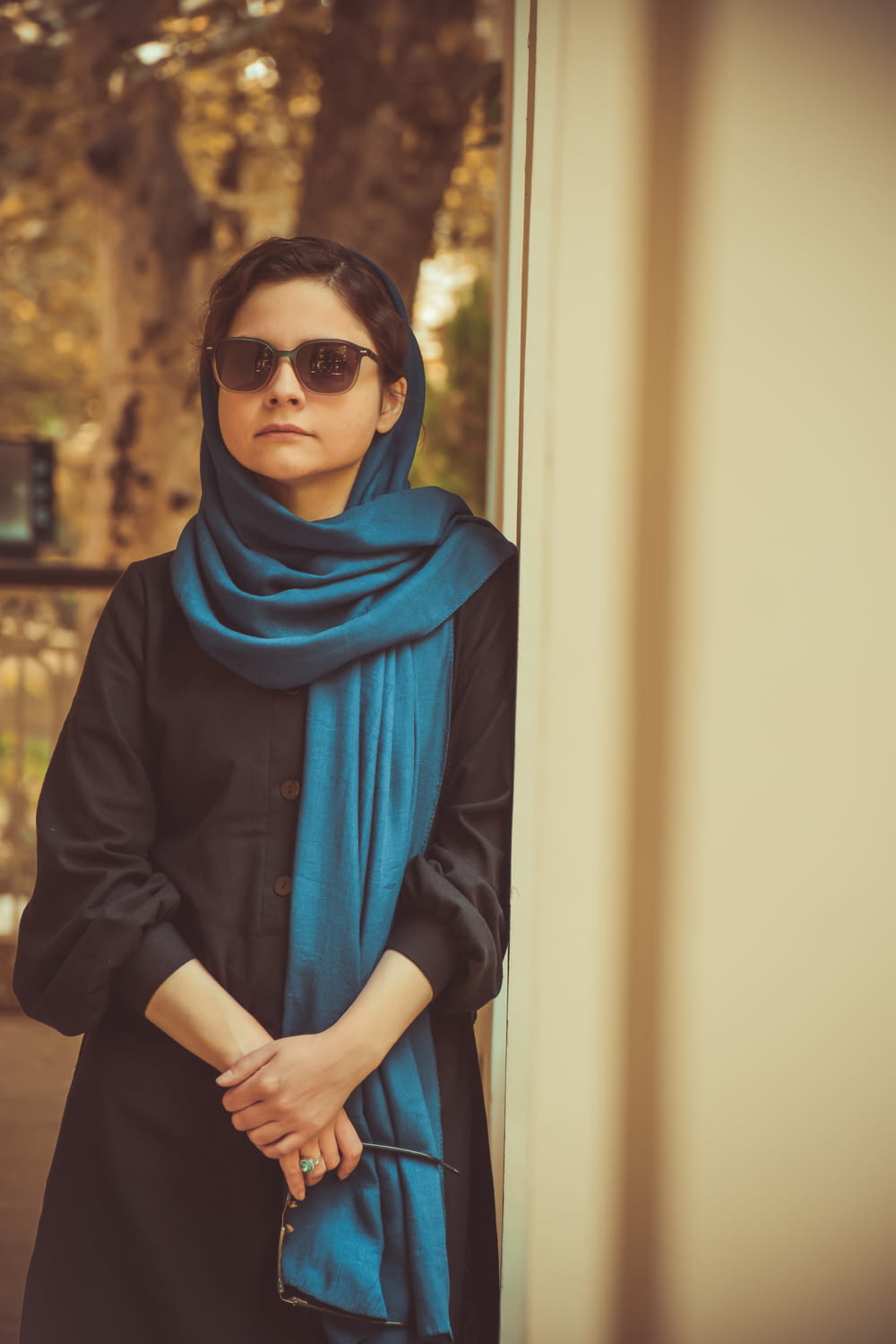 a person wearing sunglasses and a scarf