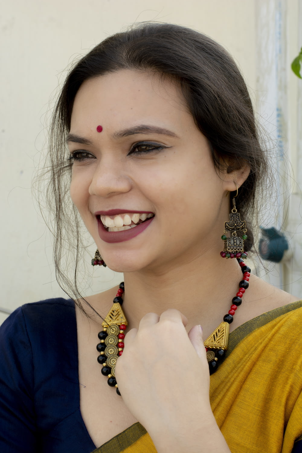 a woman smiling with her hand on her chin