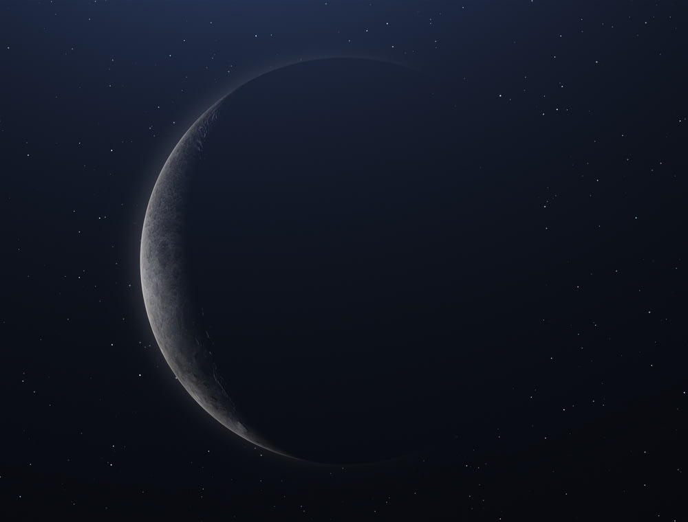 a crescent moon in the night sky