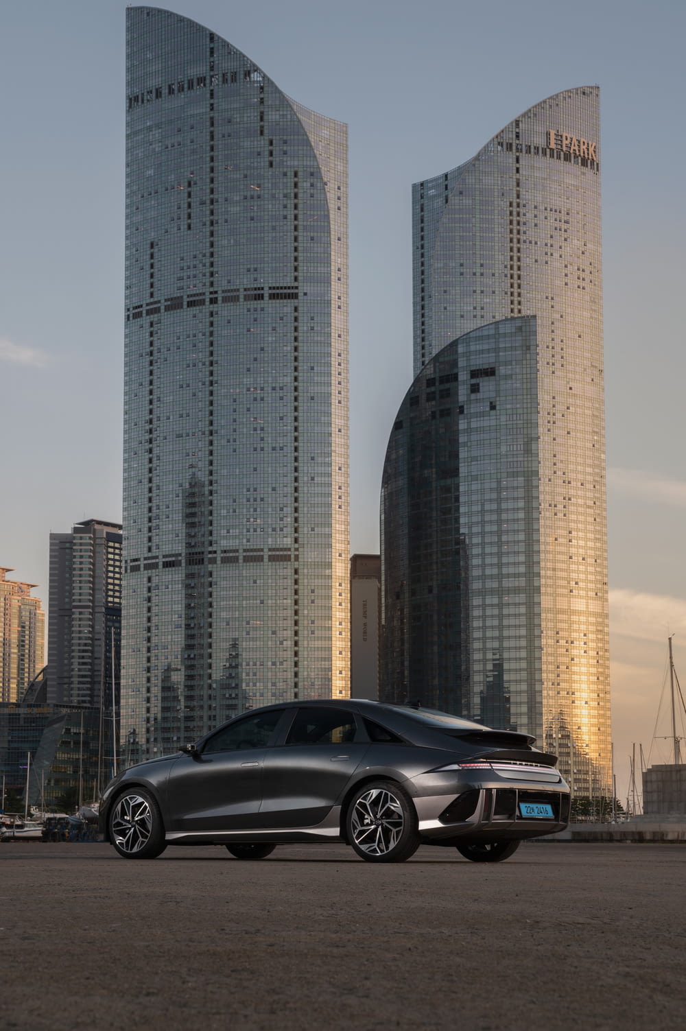 a car parked in front of a couple of tall buildings