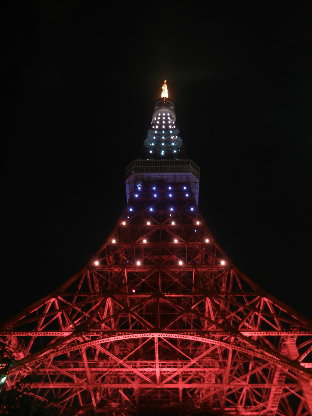 a tall tower with lights with Tokyo Tower in the background