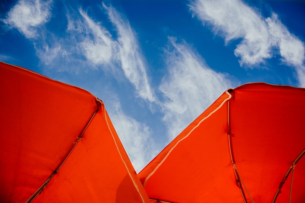 a red tent under a blue sky