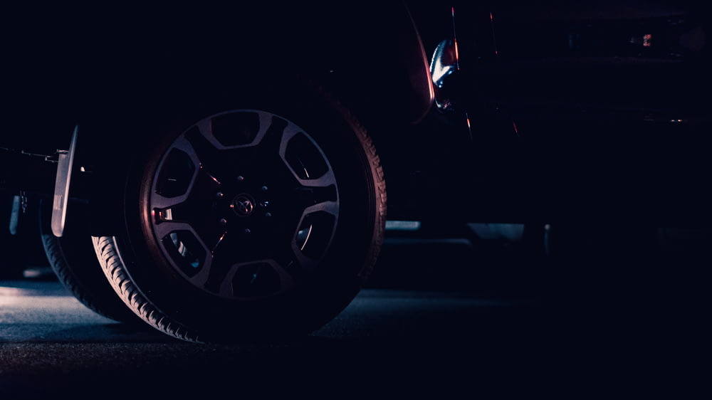 a close up of a car tire in the dark