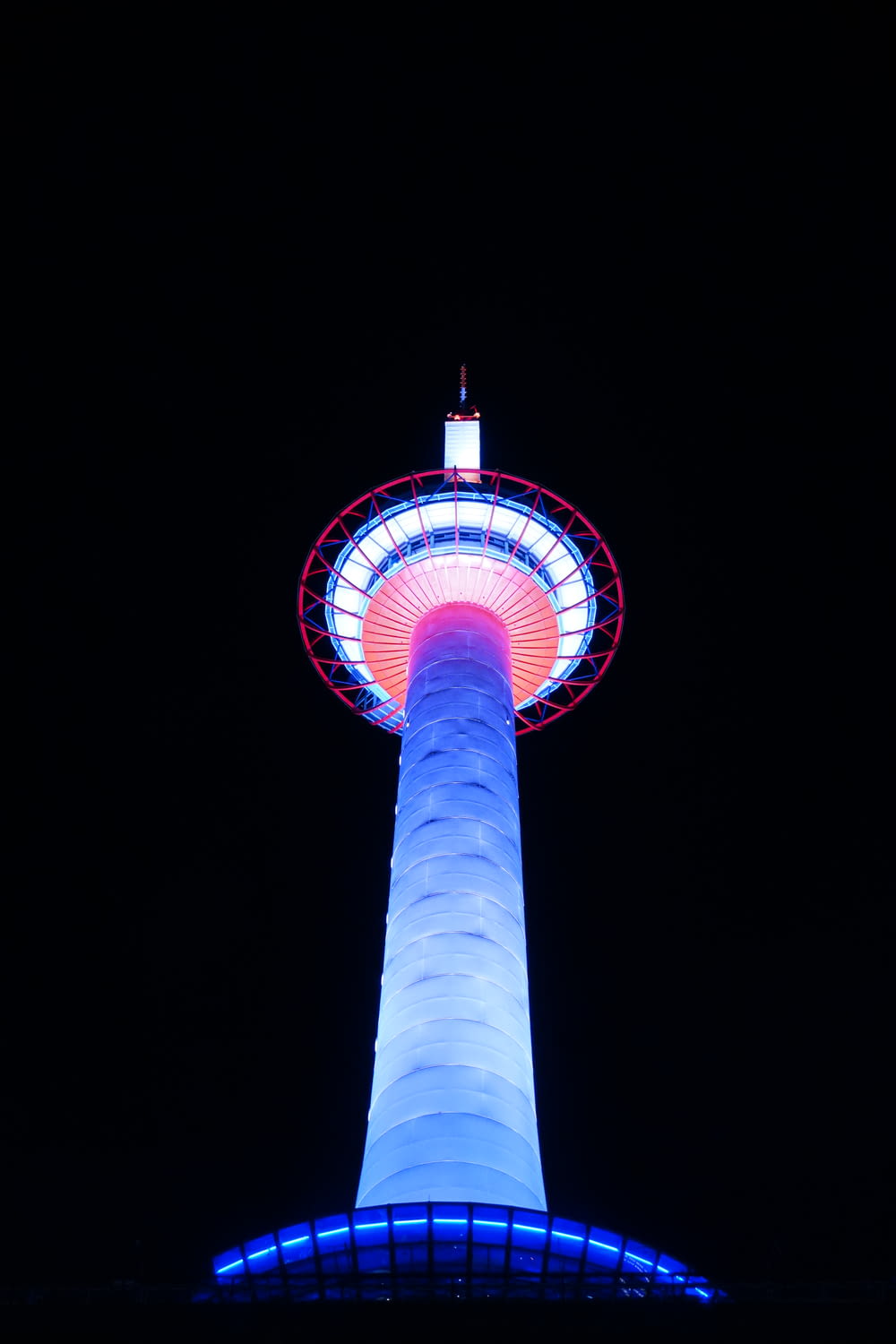 a tall tower with lights with N Seoul Tower in the background